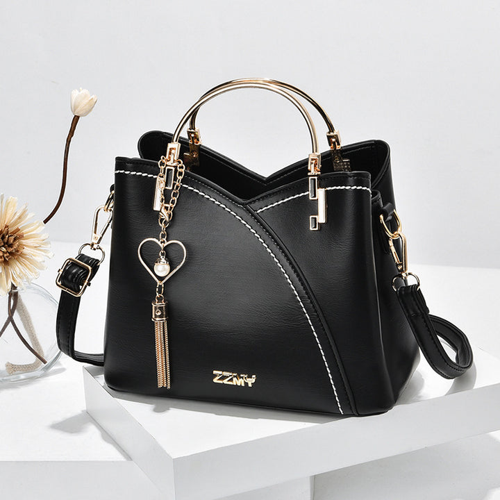 Colour block handbag with heart tassel