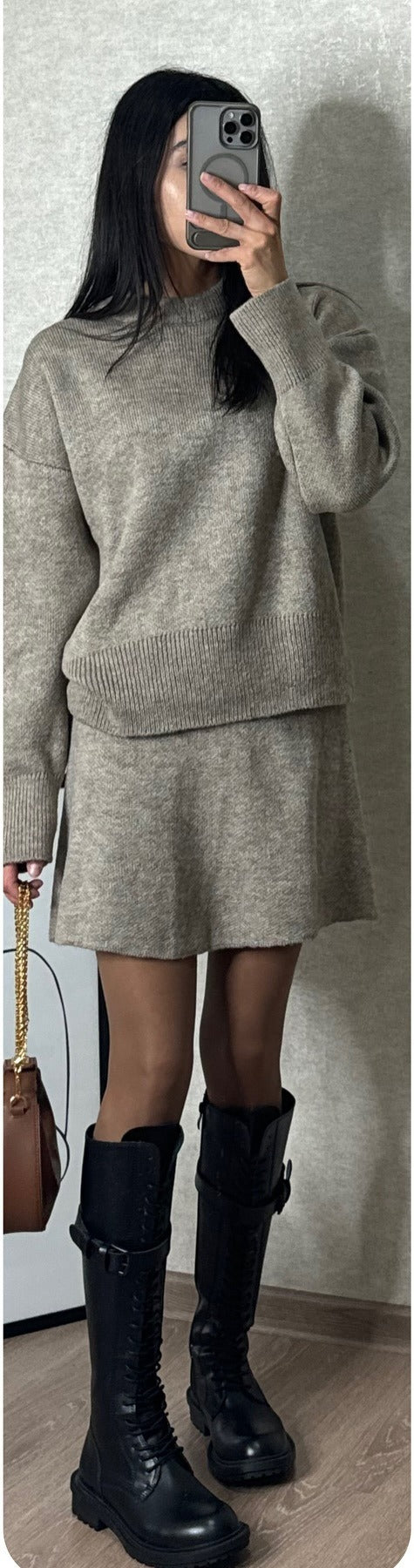 Woman in matching knitted jumper and mini skirt