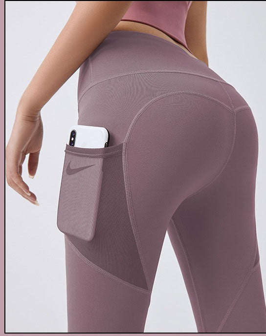 Woman wearing high-waist leggings with phone pocket