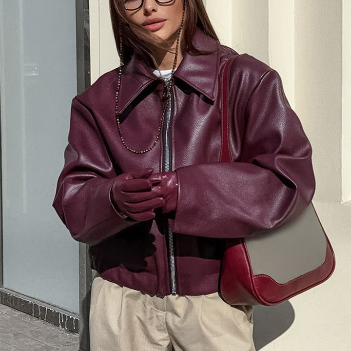Woman in a cropped burgundy faux leather jacket